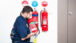 fire technician inspecting the fire extinguisher